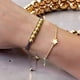 thumbnail image 1 of Pulsera macramé con balines bañados en oro, 1 of 5