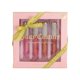 thumbnail image 1 of Set de brillo labial Juicy Couture, paquete de 4 unidades, bayas, cacao y clementina, sandía, 1 of 6