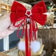 thumbnail image 3 of Accesorios de Cacampanao para Año Nuevo para niñas con lazo grande rojo, cinta de pompón roja, decoración navideña Cacampanaopin al por mayor, 3 of 5