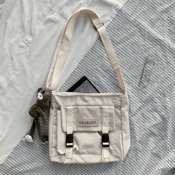 Upgrade Your Preppy Style with Our Trendy Shoulderbag - Perfect for Students! Featuring a Cute Cartoon Decor and Spacious Interior with Plastic Buckle and Zipper Closure.