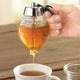 thumbnail image 3 of Sin goteo de vidrio dispensador de miel con plástico superior - servidor de jarabe de estilo panal de miel y tarro de almacenamiento temático de abejas con soporte -200ml recipiente transpar, 3 of 3