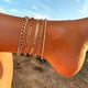 thumbnail image 3 of Pulseras de tobillo para mujer, chapadas en oro de 14 quilates, resistentes al agua, con cadena de eslabones cubanos Figaro, juego de 5 tobilleras doradas, joyería de regalo, tamaño ajustable., 3 of 5