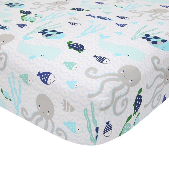 Sábana para cuna Lambs & Ivy Oceania, 100% algodón, blanca con peces azules