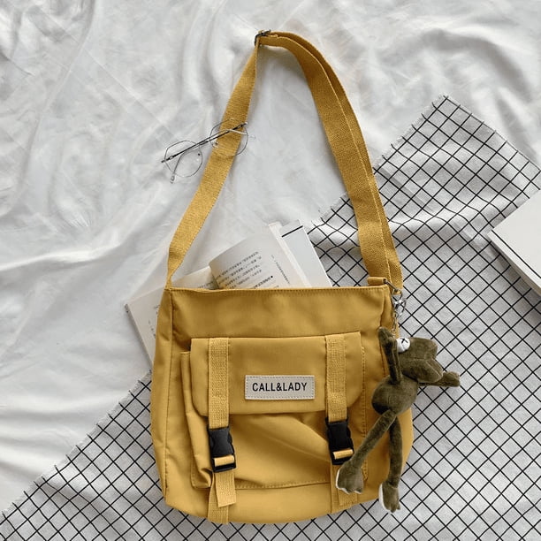 Upgrade Your Preppy Style with Our Trendy Shoulderbag - Perfect for Students! Featuring a Cute Cartoon Decor and Spacious Interior with Plastic Buckle and Zipper Closure.