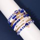 thumbnail image 4 of Set de 7 pulseras NVENF Football Heishi de arcilla elástica – Azul, 4 of 8