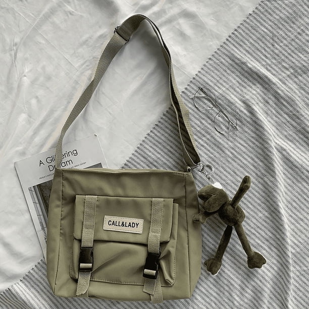 Upgrade Your Preppy Style with Our Trendy Shoulderbag - Perfect for Students! Featuring a Cute Cartoon Decor and Spacious Interior with Plastic Buckle and Zipper Closure.